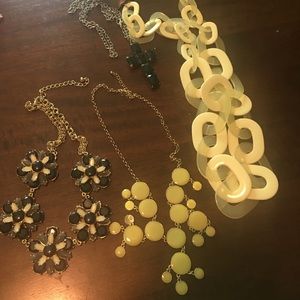 Four necklaces in the colors black, tan, or yellow